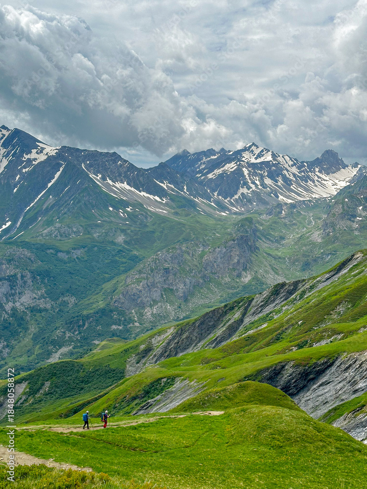 Fototapeta premium Couple Hiking down the Tour du Mont Blanc near the Col du Bonhomme in Summer