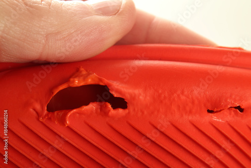 Canvastavla Damaged hot water bottle with holes, close up