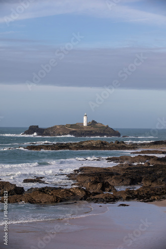 Godrevy Lighthouse at Godrevy Beach in Cornwall, UK.