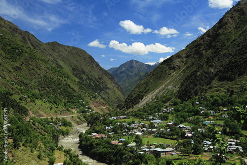 Wallpaper Mural View of the valley with a river snaking through the base surrounded by lush green mountains, a small village nestled amidst the landscape, Neelum Valley, Azad Kashmir, Pakistan. Torontodigital.ca