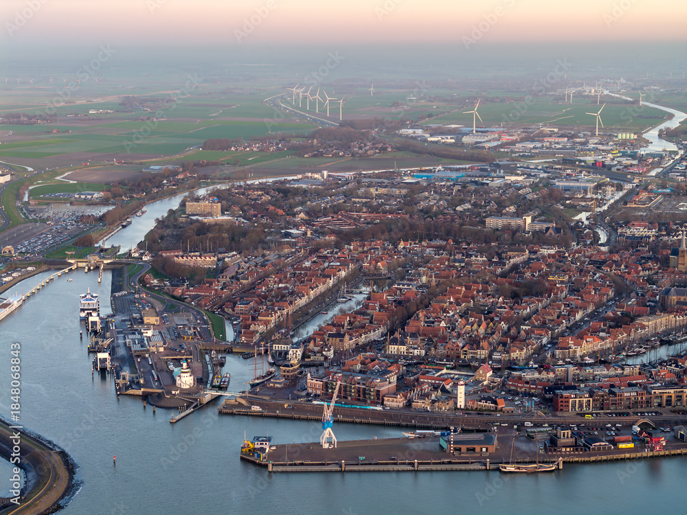 Naklejka premium Aerial drone view of Harlingen city centre and harbour at sunset 