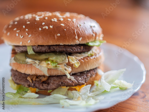 Double Layer Beef Hamburger on a Plate with Fresh Lettuce