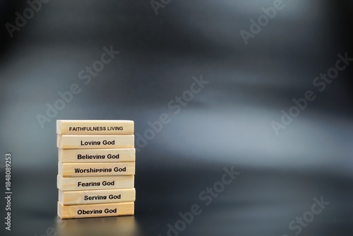 Fotografia Faithfulness Living Wooden Block Stack Grey Shaded Background