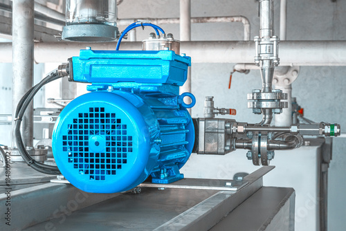 Industrial equipment. New blue electric motors with pumps on the stainless steel production line. Industrial background. Additive pump station in petrochemical technology.