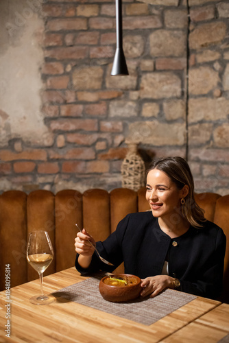 Woman enjoys a warm meal an...