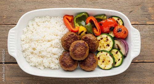 Top-Down View of Beef Kofta Meatballs with Rice and Grilled Vegetables in Ceramic Dish
