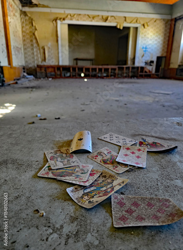 Beautiful view of playing cards in the foreground of a stage in an abandoned building