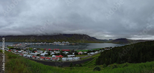 Beautiful view of the small town of Ísafjörður and the wonderful fjord behind it with high mountains 