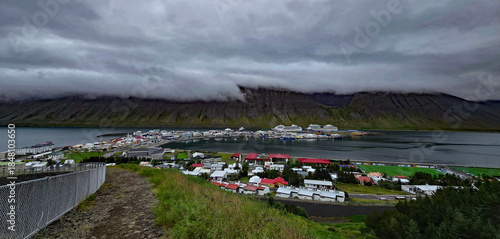 Beautiful view of the small town of Ísafjörður and the wonderful fjord behind it with high mountains 