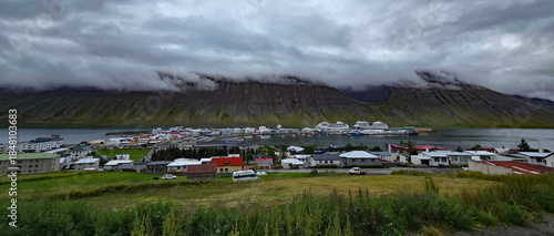 Beautiful view of the small town of Ísafjörður and the wonderful fjord behind it with high mountains 