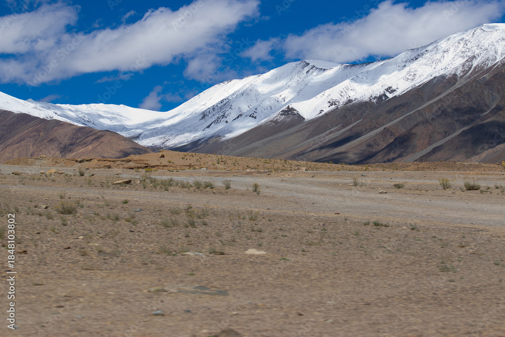 Fototapeta premium Beautiful snow peaks, high ridge mountains of Ladakh with beautiful blue sky background, Changla Pass, Jammu and Kashmir, India, ice, nature, winter, cold, ridge, glacier, white, travel, hills, white