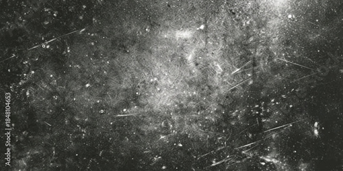 A dark and scratched surface texture in monochrome, capturing a vintage grunge effect