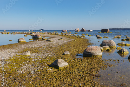 Narrow stone path across shallow coastal water at low tide