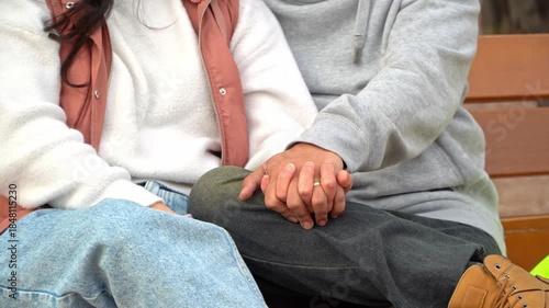 Married couple holding hands with wedding rings on Valentine’s Day