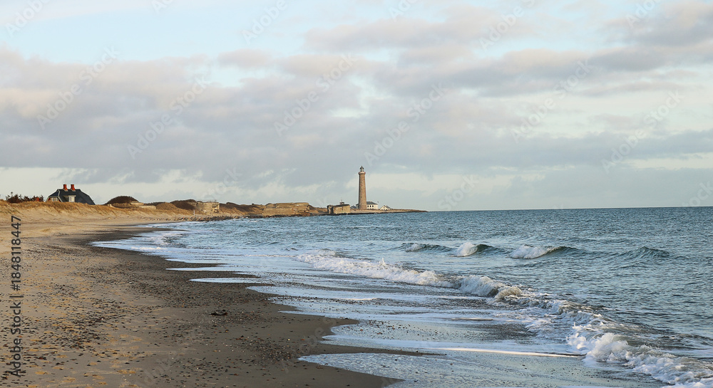 Naklejka premium Morris Island Lighthouse from the shoreline of Folly Beach near Charleston, South Carolina.