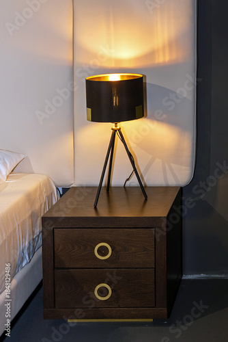 Retro lamp on a nightstand inside bedroom interior