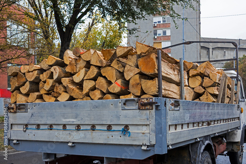 Pile of cut wood inside pickup truck on urban street