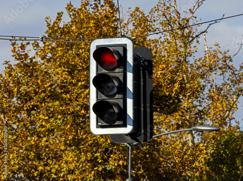 Red signal traffic light sign outside on a street