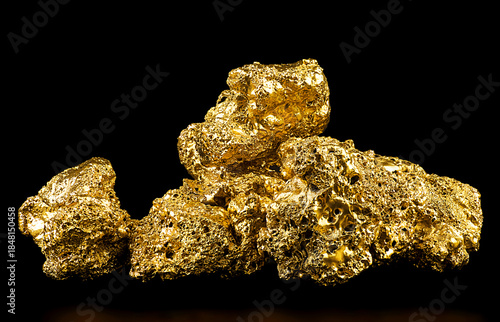 Pile of pure gold from the mine on black background. Gold nuggets. Finance and business concept.