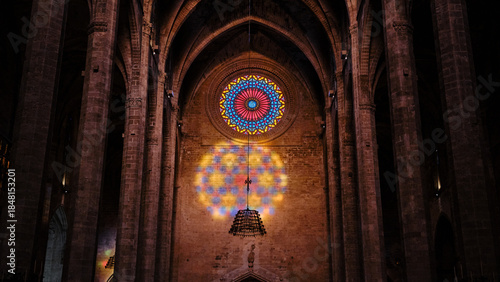 Stained glass rose window illuminating Gothic cathedral architecture