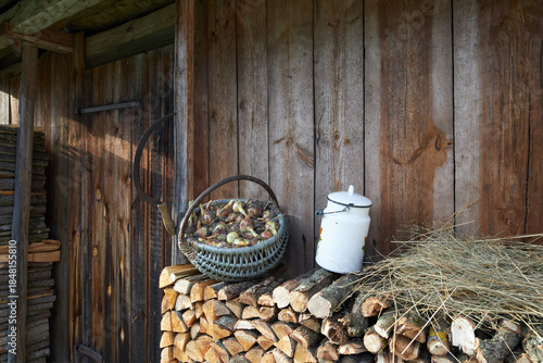 Objects of ancient village life near a wooden wall.