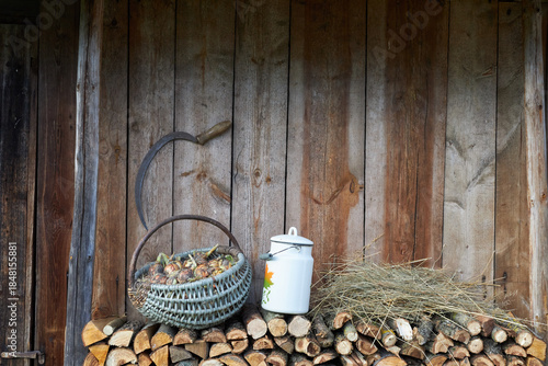 Objects of ancient village life near a wooden wall.