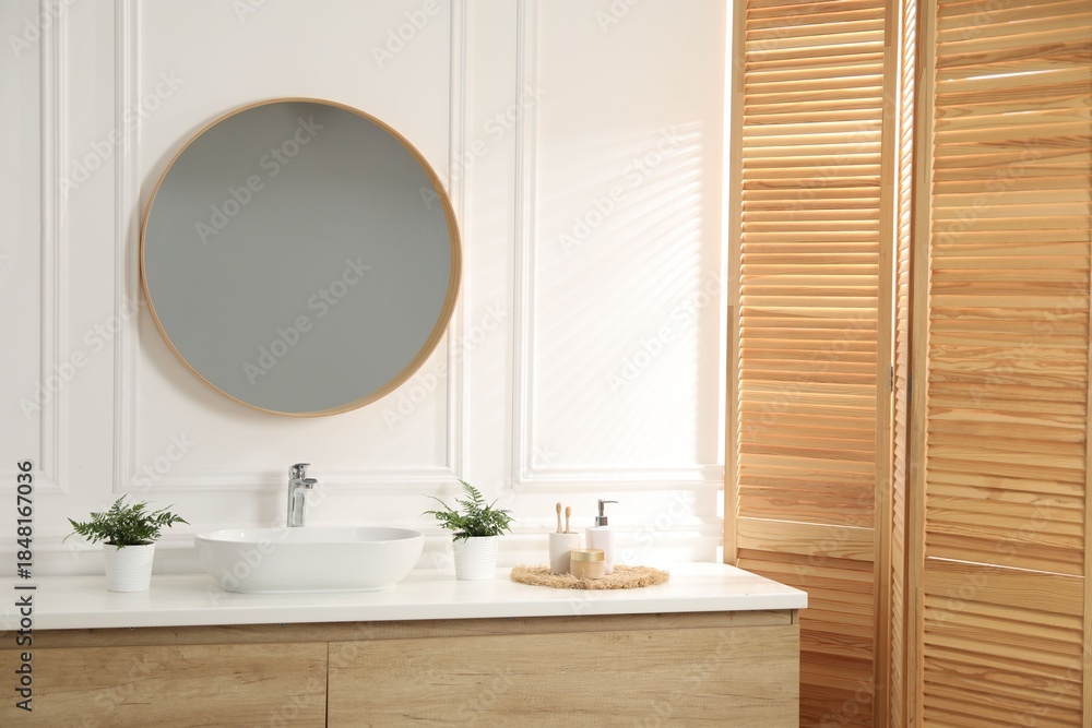 Fototapeta premium Bathroom with stylish mirror, vessel sink and houseplants. Interior design