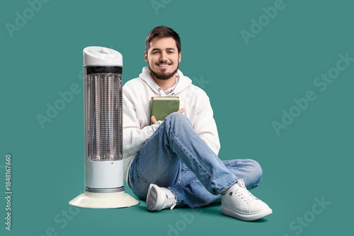 Young man with book and ele...