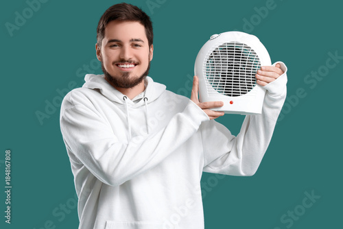 Young man with electric fan...