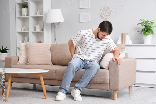 Young man with hemorrhoids ...