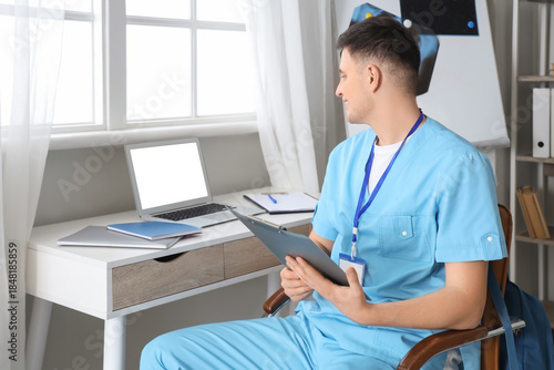 Male medical intern with cl...
