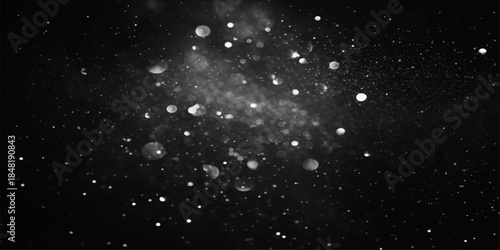 Abstract falling snowflakes and shimmering particles drift in slow motion against a dark blue winter night sky filled with glowing stars and cosmic galaxy dust