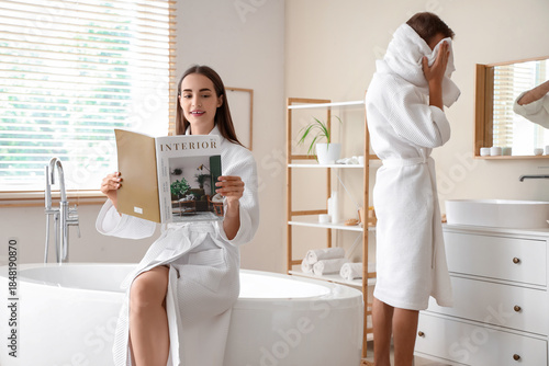 Young woman reading magazin...