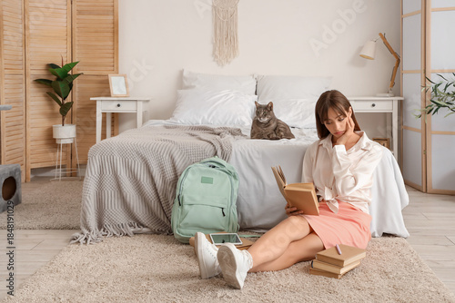 Happy female student with b...