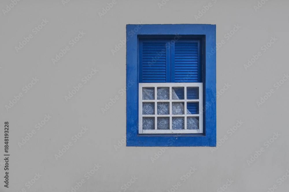 Fototapeta premium Blue colonial window in historic brazilian, architecture, minimalist facade photography, traditional brazil house exterior, pastel wall, travel aesthetic, cultural wall art