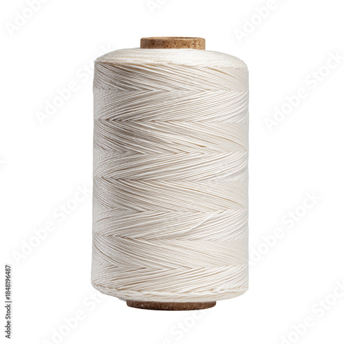 Thread Spool With White Thread on a Wooden Surface Showcasing a Simple Sewing...