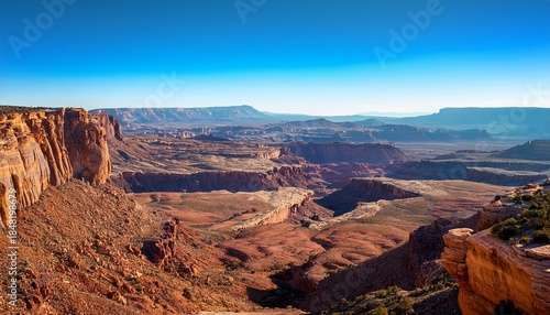 sprawling vista featuring mountains canyons and desert terrain