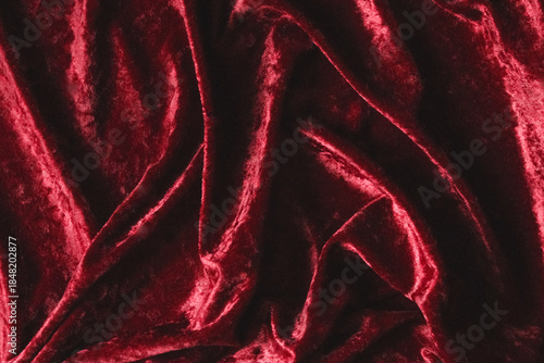 Φωτογραφία Red velvet fabric background showing soft luxurious texture and draped folds of