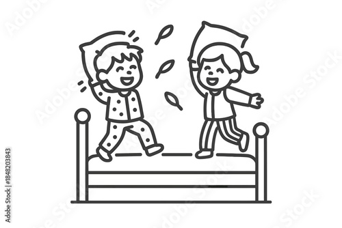 Happy children jumping and having a playful pillow fight on a bed