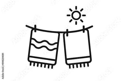 Towels drying on clothesline under bright sun