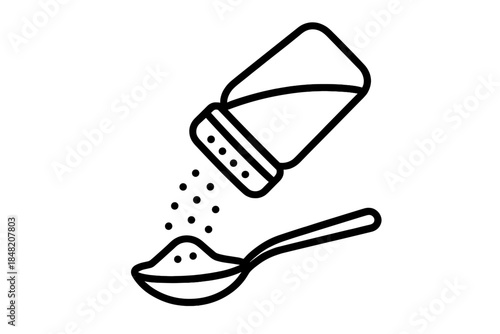 Salt shaker pouring onto a spoon