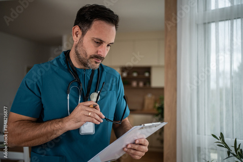 Doctor examining medical records holding clipboard glasses