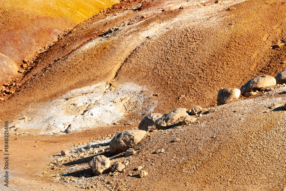 Obraz premium Krýsuvík is a vibrant geothermal area on Iceland's Reykjanes Peninsula, famous for its colorful, mineral-stained hills, bubbling mud pots, steaming fumaroles (steam vents), and hot springs.