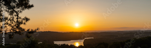 Sunset Orange Light on Neuvic Lake water in August Summer - Limousin
