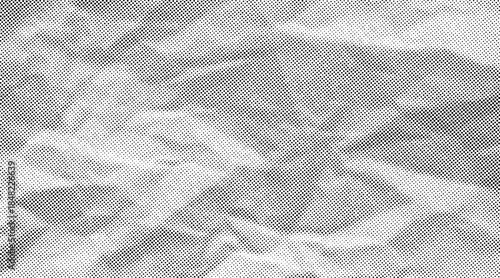 Halftone crumpled paper texture with black a dotted, rough, and wrinkled surface. Wite creased sheet background in comic pop-art style, featuring grainy folds and gritty distressed details.
