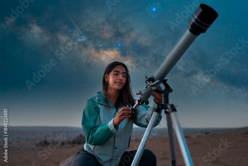 Woman adjusting a telescope, stargazing under the night sky and milky way