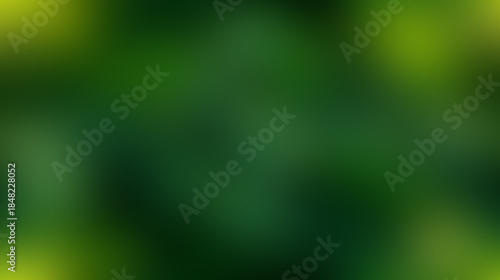 A soft focus abstract background of deep green and yellow hues.