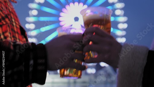 Couple cheers with beer at amusement park