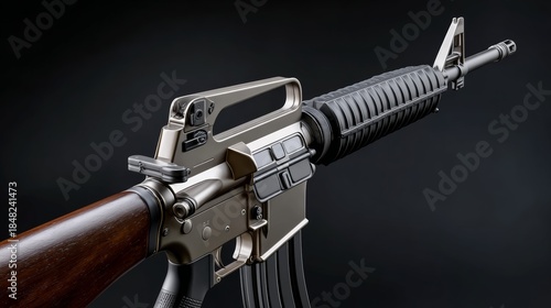 A close up of a gun with a black barrel and a silver handle. The gun is a rifle and is in a black and white photo