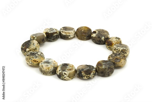 Handmade Baltic amber jewelry bracelet made of chalk amber stones on white background